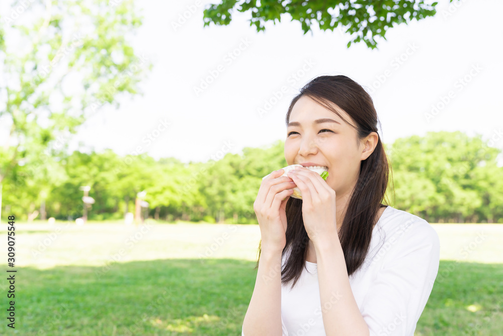 サンドイッチを食べる女性 屋外 サンドイッチを食べる女性 屋外