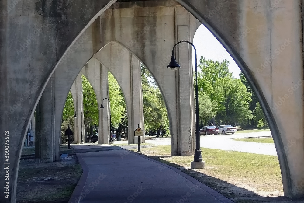sidewalk under a concrete bridge