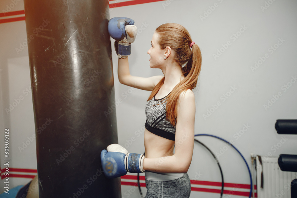 Girl in a gym. Woman training. Lady in a sportswear