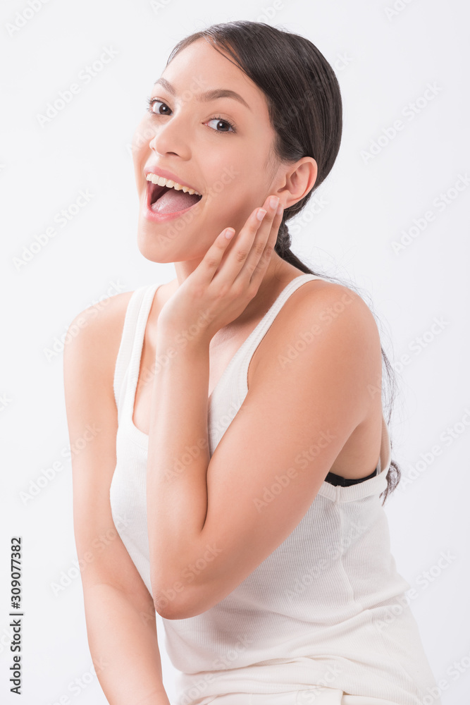 beautiful young woman with clean fresh skin touch own face . facial treatment . cosmetology , beauty and spa . beautiful young woman with clean fresh skin touch own face . facial treatment . cosmetology , beauty and spa .