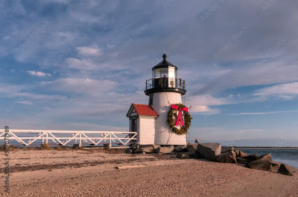 Brand Point Lighthouse, located on Nantucket Island in Massachusetts, decorated for the holidays with a Christmas wreath and crossed oars.