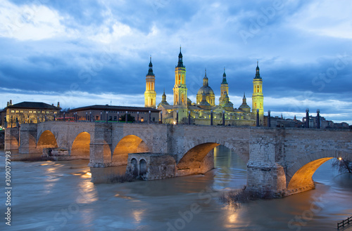 Zaragoza - The bridge Puente de Piedra and Basilica del Pilar at dusk.