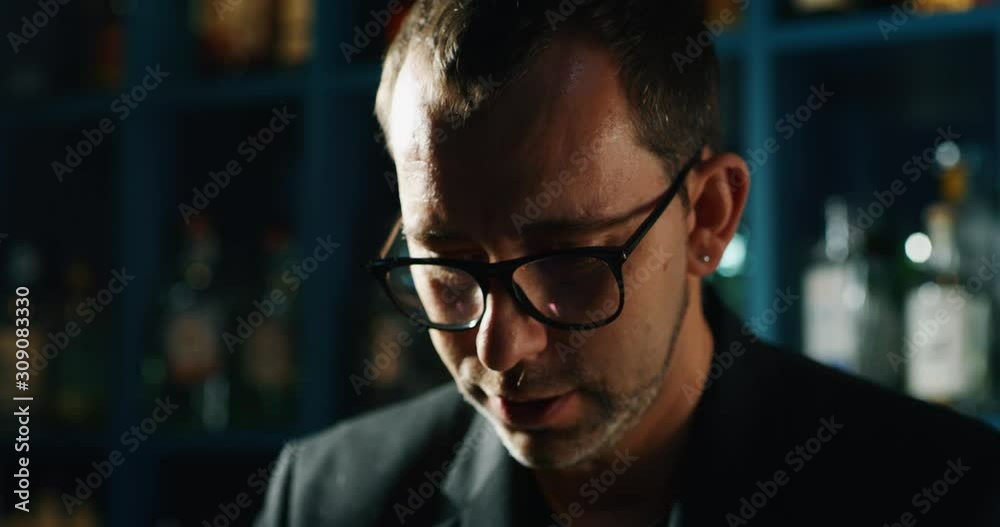 Close up of a professional bartender is preparing an alcoholic cocktail with ice cubes to customers at the bar or disco club. Close up of a professional bartender is preparing an alcoholic cocktail with ice cubes to customers at the bar or disco club.