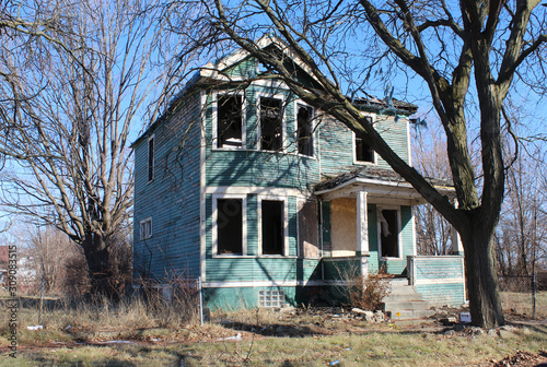 Abandoned green wooden home in Detroit's Poletown neighborhood