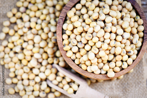 Soybean on bolw and the sack background top view - dry soy beans , soya beans
