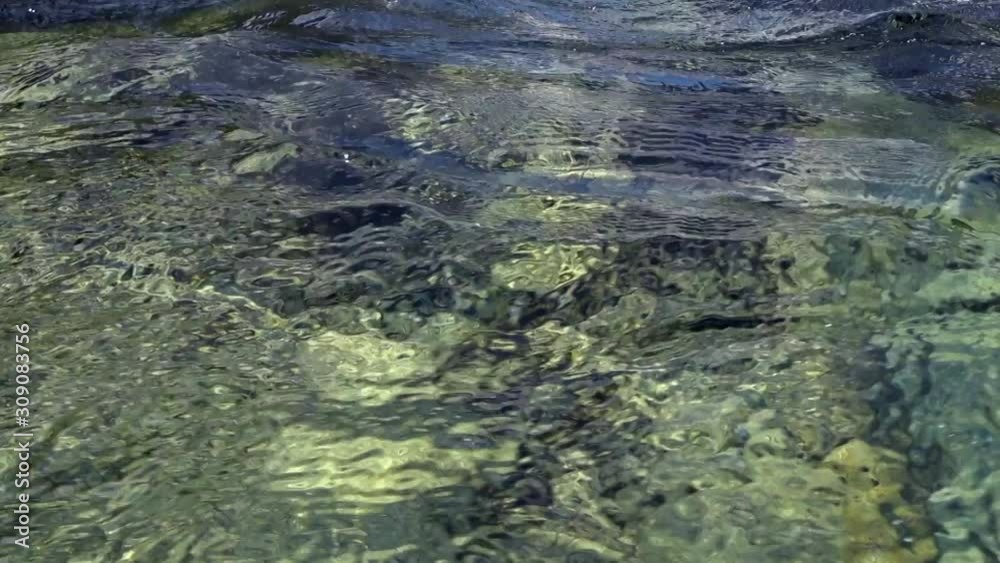 The fast flowing waters of the mountain river sharpen the stone and create incredible patterns. Underwater view. The fast flowing waters of the mountain river sharpen the stone and create incredible patterns. Underwater view.