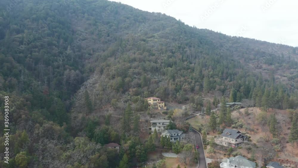 Circling a Yellow Hill House in the Middle of the Forest in Oregon Mountains 