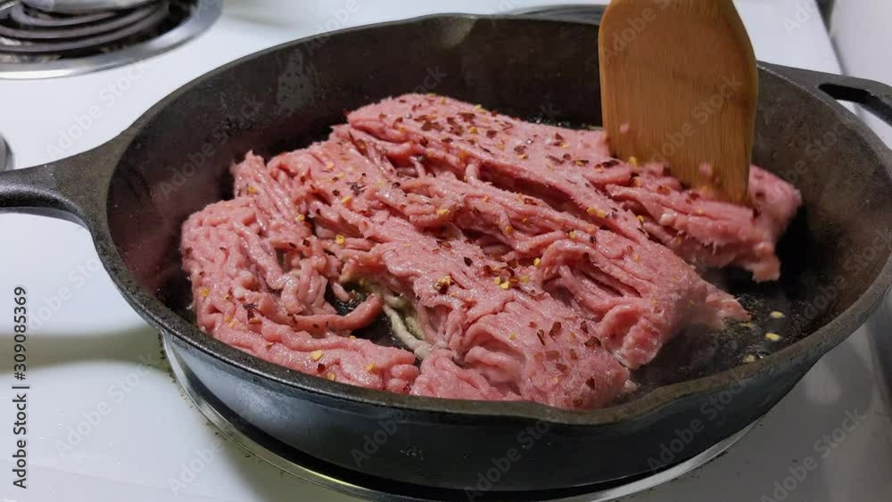 Frying ground beef on a cast iron skillet. Frying ground beef on a cast iron skillet.