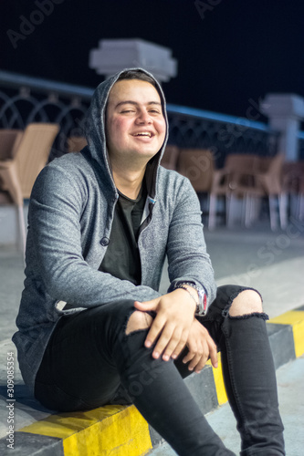 young man out in the street at night 