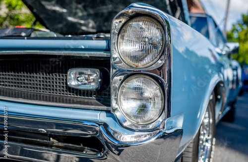 Blue shiny vintage retro car with open hood at a street seasonal exhibition © vit