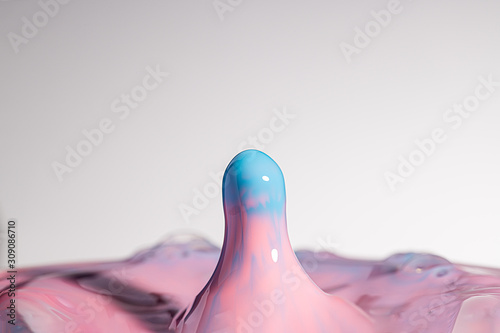 High resolution high megapixel image of a water drop splash with pink, red, blue, and baby blue, representing themes of change, impact, gender, fluidity, or gender reveal
