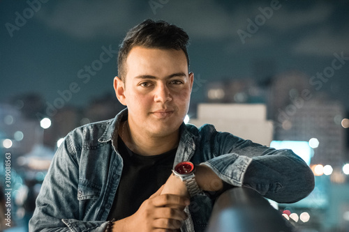 young man out in the street at night 