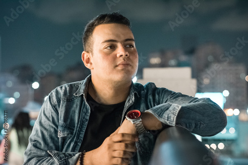 young man out in the street at night 