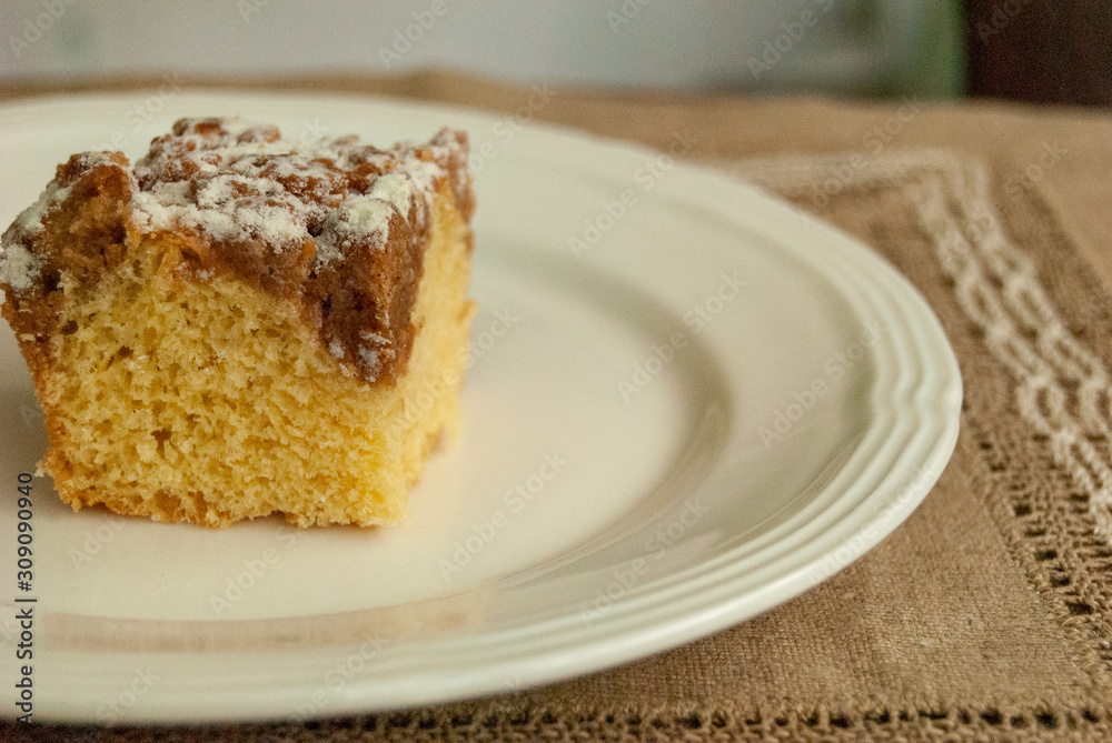 Single piece of coffee crumb cake served on a white plate Single piece of coffee crumb cake served on a white plate