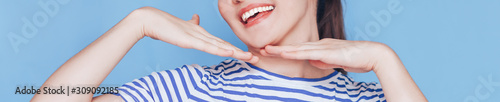 Smile of young woman with great healthy white teeth. on blue background.