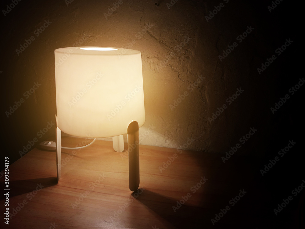 The lamp in a dark room provides light
