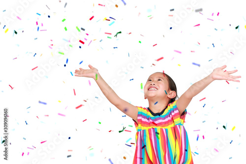 Happy little child girl with colorful confetti on white background. Happy New Year or Congratulation Concept.