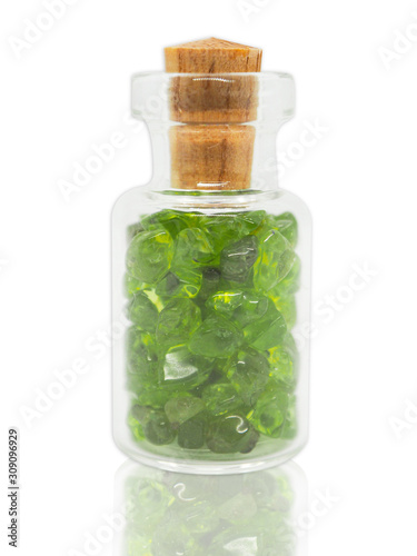 Green stone in a glass bottle