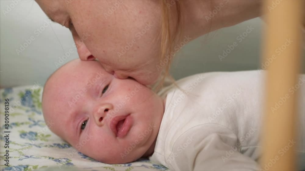 Portrait of adorable newborn baby boy with blue eyes in his bed Portrait of adorable newborn baby boy with blue eyes in his bed
