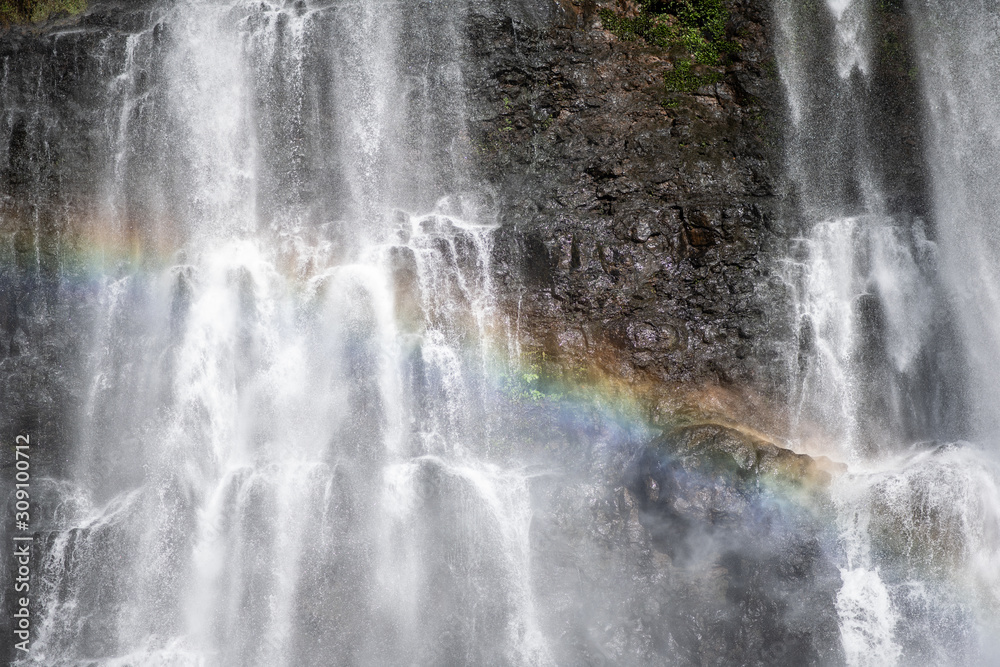 Beautiful rainbow in the paradise waterfall on the big island Beautiful rainbow in the paradise waterfall on the big island
