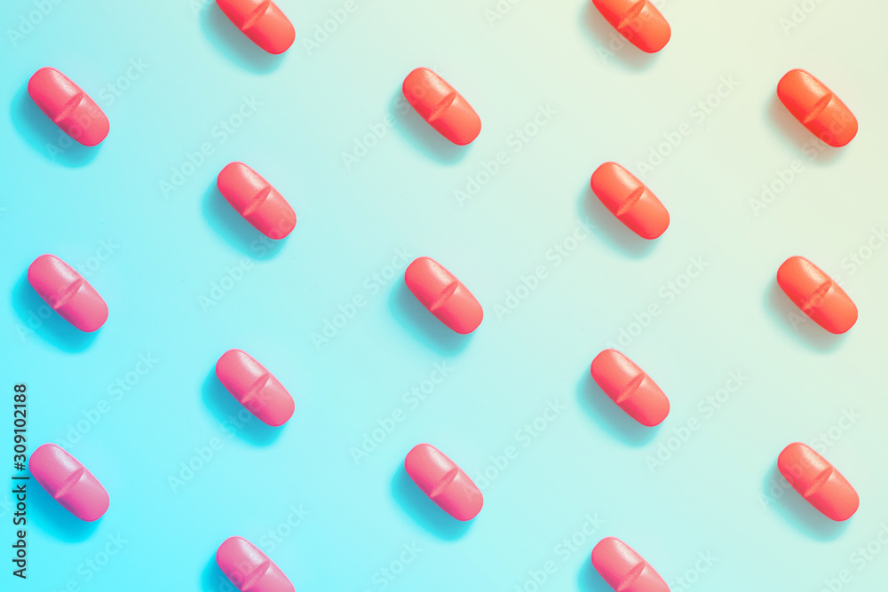 pattern of red pills on a colorful background. concept of hallucinations. pattern of red pills on a colorful background. concept of hallucinations.