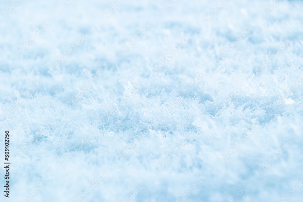 Abstract background of fresh white snow closeup. Winter snowflakes texture. Winter snow. Snow texture Top view of the snow. Natural winter background