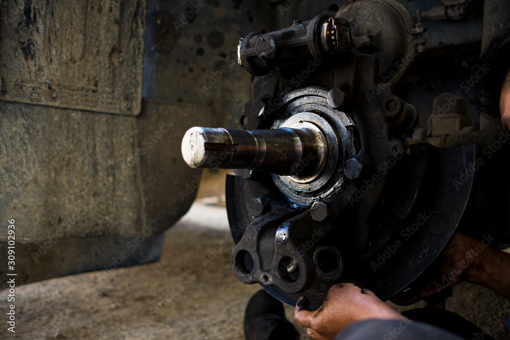 The mechanic is changing the truck brake pads.