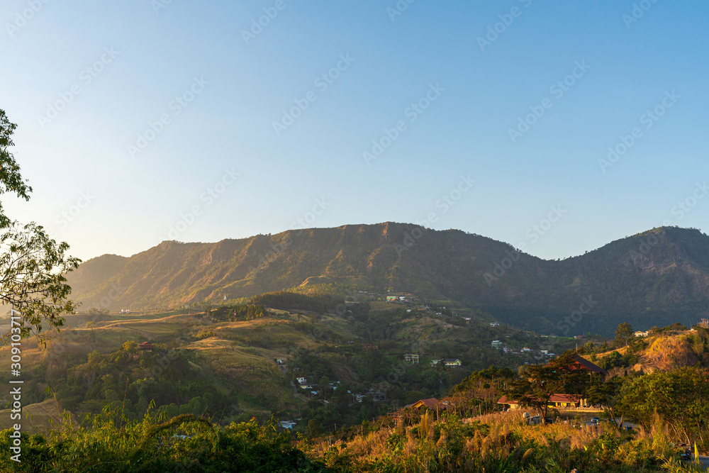 Fototapeta premium beautiful blue sky high peak mountains mist fog wildlife green forest at Khao Koh Phu Tub Berk Phetchabun Thailand guiding idea long weekend for backpacker camping hiking 