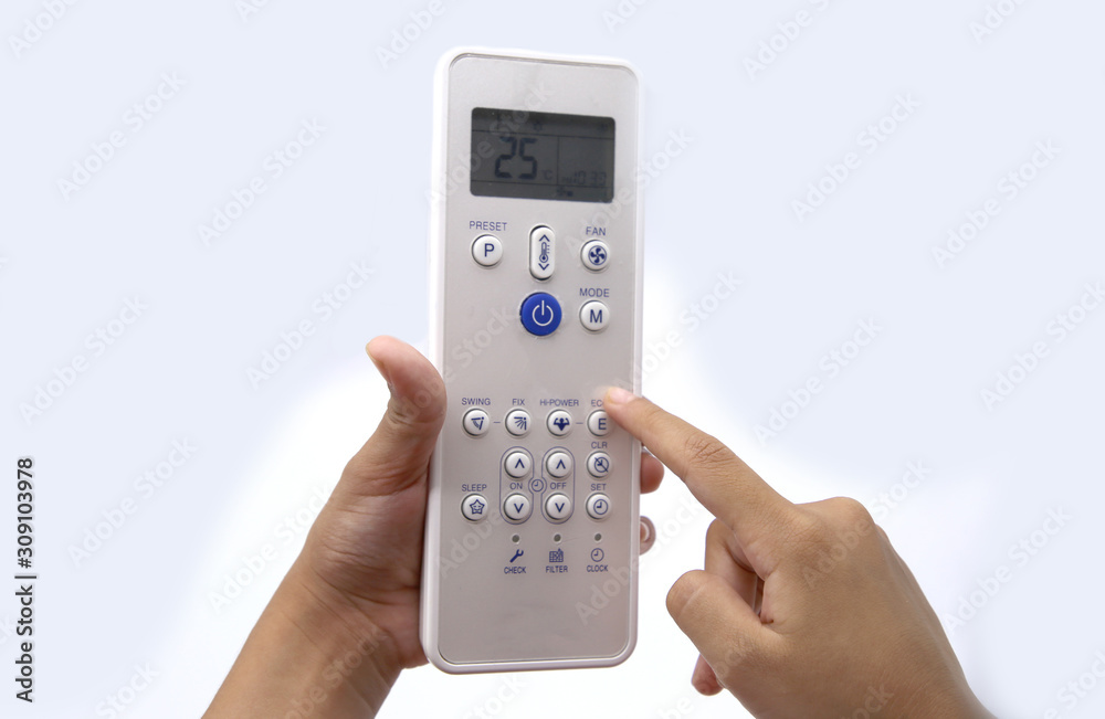 Hand holding air conditioner remote control on white background Hand holding air conditioner remote control on white background