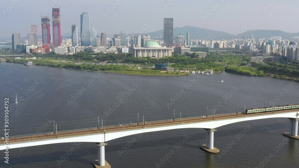 Metro train crossing Han river in front of Yeouido island, Seoul, South Korea aerial shot Metro train crossing Han river in front of Yeouido island, Seoul, South Korea aerial shot