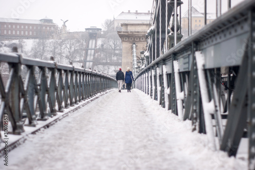 Photography Two friends go walking on a bridge in winter