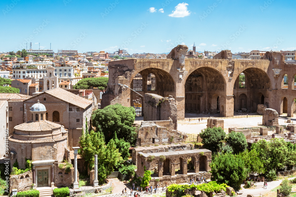 Panoramic view of remains of Roman Forum and cityscape of Rome in hot day in summer, Rome, Italy.