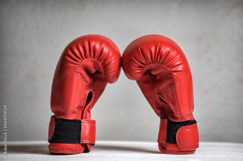 Pair of red boxing gloves on a white background. Close-up