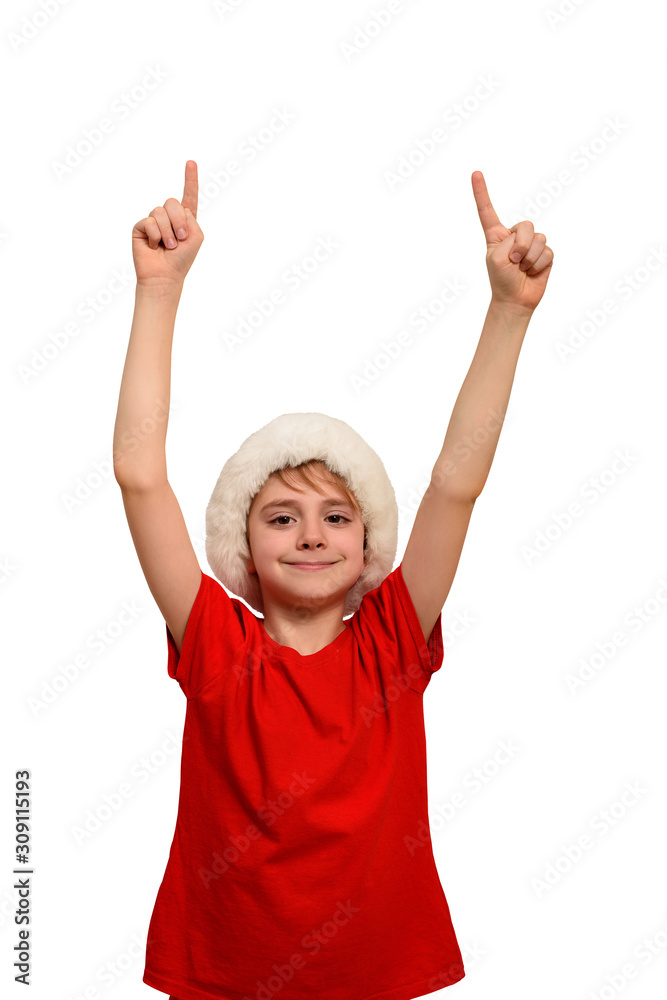 Smiling boy in Santa hat points fingers up. Isolate Smiling boy in Santa hat points fingers up. Isolate