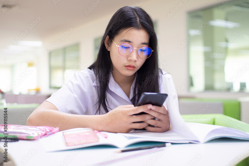 Beautiful Asian women use the telephone to find information in education. Beautiful Asian women use the telephone to find information in education.