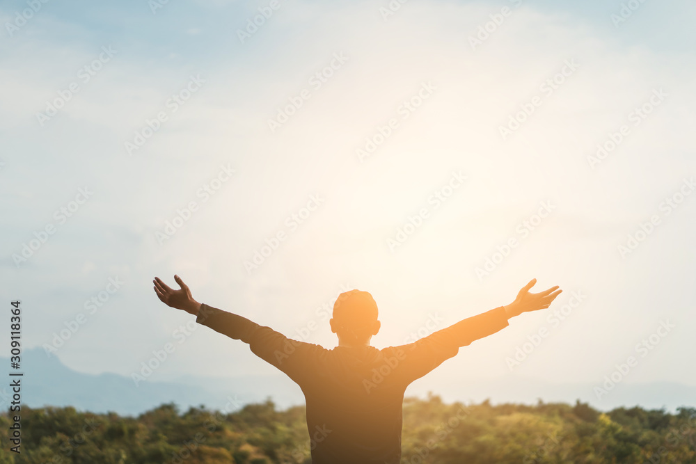 Copy space of man rise hand up on top of mountain and sunset sky abstract background. Copy space of man rise hand up on top of mountain and sunset sky abstract background.