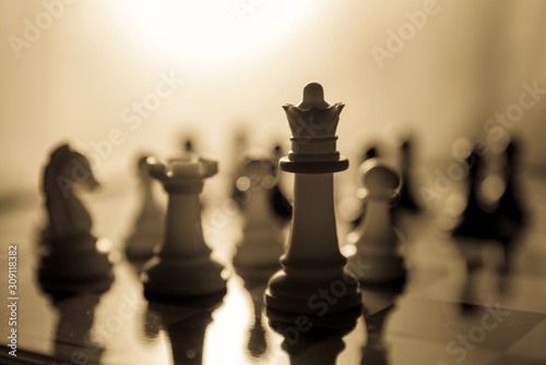 Vintage cinematic look shot of chess pieces on chess board
