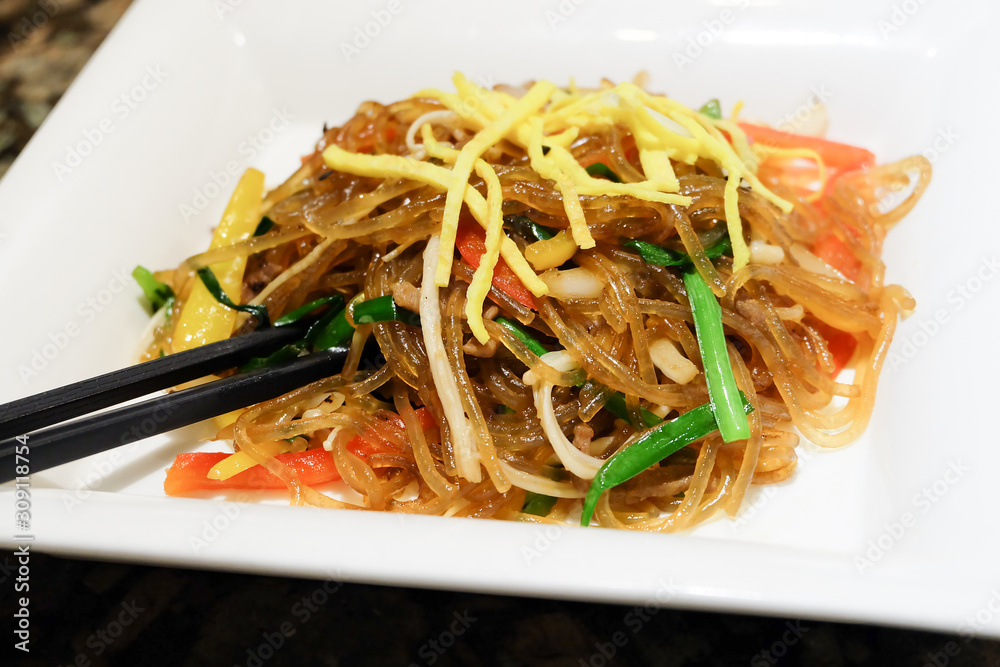 Korean dish called Japchae made from Noodles, stir fried in sesame oil with various vegetables. Korean dish called Japchae made from Noodles, stir fried in sesame oil with various vegetables.