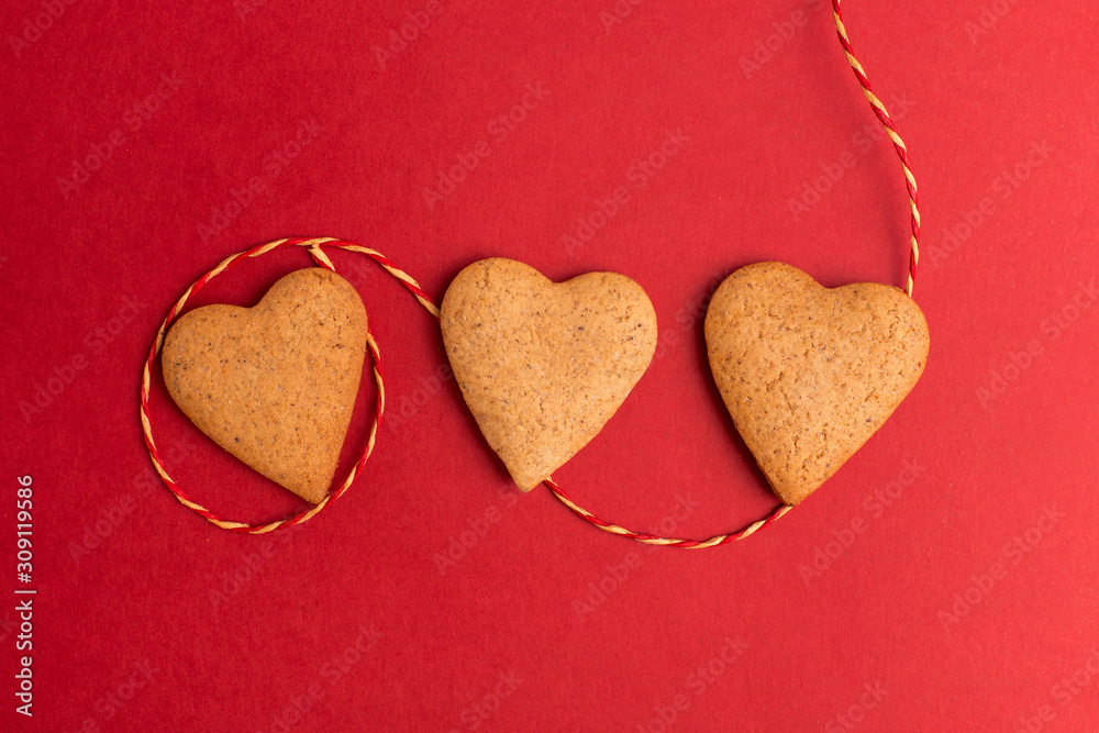 Fototapeta premium red background with heart cookie, valentines day