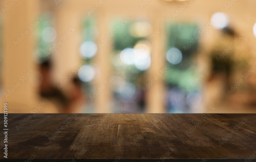 Empty dark wooden table in front of abstract blurred bokeh background of restaurant . can be used for display or montage your products.Mock up for space.