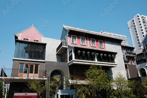 details of a modern loft construction of houses and clean blue sky, contrast of buildings.