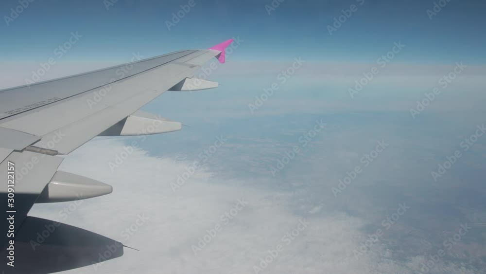 Spectacular view with clouds on ground, sky from airplane illuminator. Flying by plane, high altitude, wing of aircraft. Horizon cannot be seen. Spectacular view with clouds on ground, sky from airplane illuminator. Flying by plane, high altitude, wing of aircraft. Horizon cannot be seen.