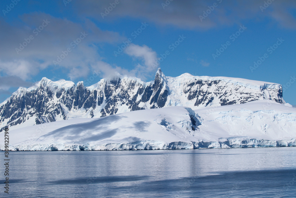 Snow-capped mountains on an island along the coasts of the Antarctic Peninsula, Palmer Archipelago, Antarctica