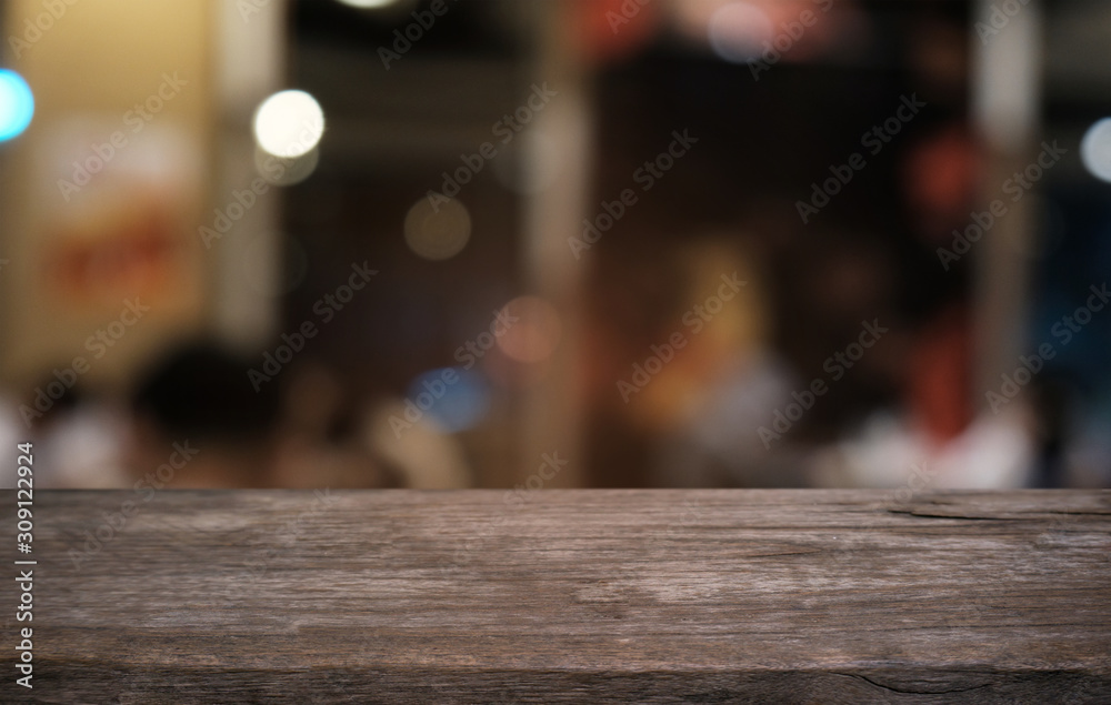 Empty dark wooden table in front of abstract blurred bokeh background of restaurant . can be used for display or montage your products.Mock up for space.