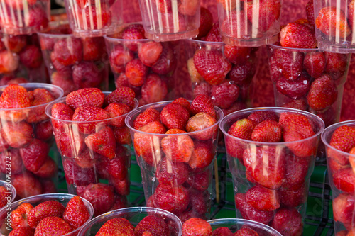 Strawberries in clear plastic cups for sale in the street food, Thailandhatuchuk weekend market, Bangkok, Thailand