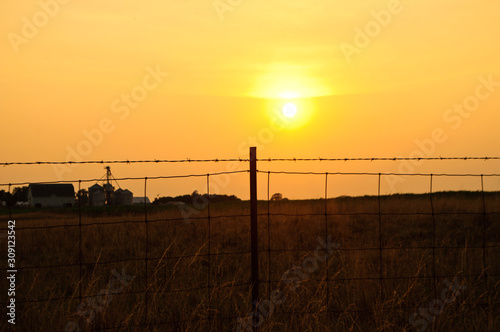 sunset through fence