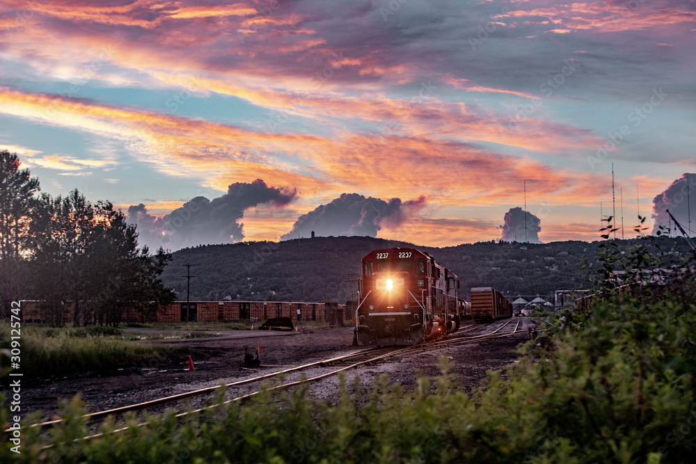 sunset over the city with a train