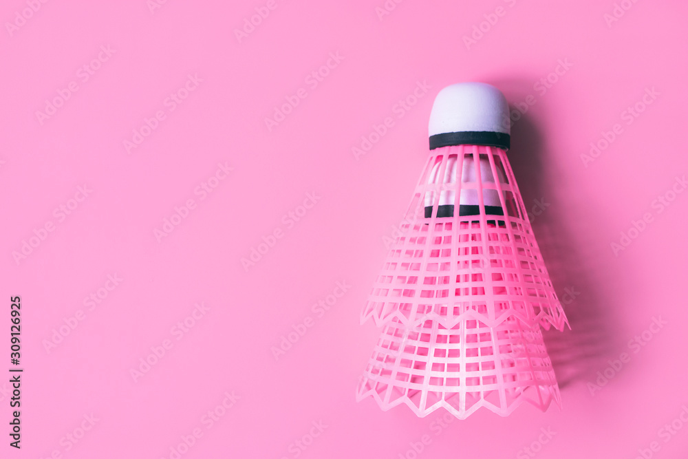 Two pink shuttlecock with white tip for tennis on a pastel dusty pink background. Flatlay. Place for text. Sports female badminton concept