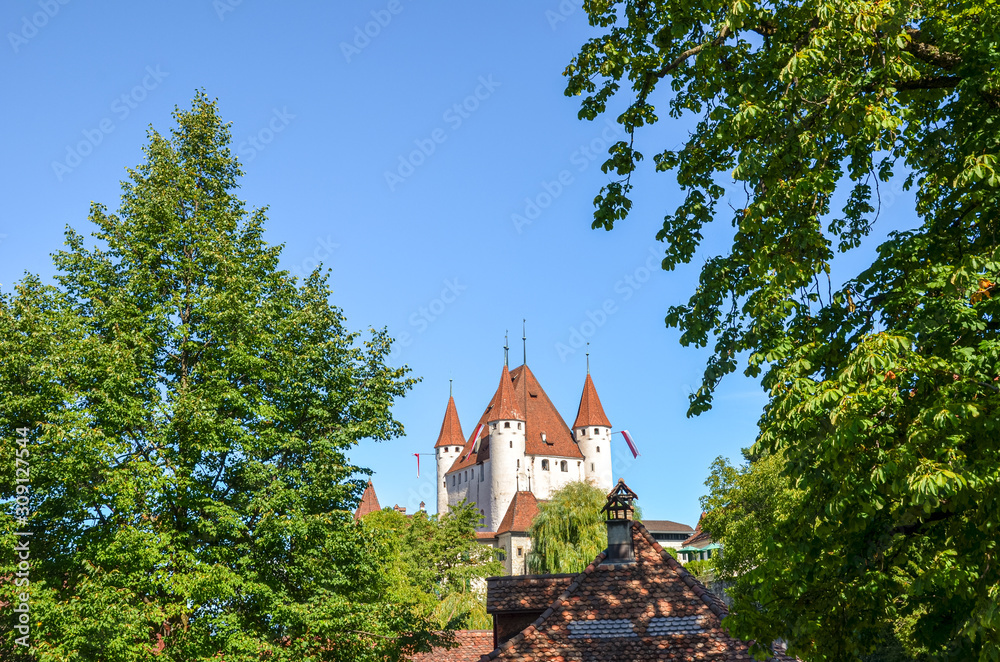 Medieval Thun Castle in Thun, Switzerland photographed with the adjacent green trees. 12th-century Gothic-style castle is a Swiss heritage site of national significance. Tourist attraction