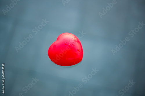 The Close up of heart on the water background.